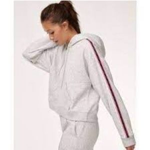 - TNA cream cropped hoodie with side stripes. Size medium.